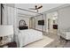 Stylishly staged bedroom with ensuite bathroom featuring wood-look flooring, ceiling fan, and modern decor at 6150 Bunker Commons Ct, Las Vegas, NV 89108