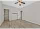Spacious bedroom with wood-look floors, a ceiling fan, and access to a walk-in closet and additional rooms at 6150 Bunker Commons Ct, Las Vegas, NV 89108