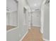 Bright hallway featuring tile floors, neutral paint, and doorways leading to various rooms of the house at 6150 Bunker Commons Ct, Las Vegas, NV 89108