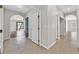 Bright hallway with tile flooring, leading to an open living space and backyard at 6150 Bunker Commons Ct, Las Vegas, NV 89108