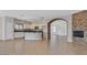Bright, open kitchen featuring white cabinets, dark countertops, a breakfast bar, and an adjoining living space at 6150 Bunker Commons Ct, Las Vegas, NV 89108