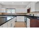 Modern kitchen with stainless steel appliances, tile backsplash and granite countertops at 6150 Bunker Commons Ct, Las Vegas, NV 89108
