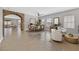 Staged living room with stone archway, seating area, dining area, and tile floors at 6150 Bunker Commons Ct, Las Vegas, NV 89108