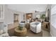Staged living room with open layout, tile floors, archway, and comfortable seating area at 6150 Bunker Commons Ct, Las Vegas, NV 89108