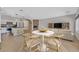 Open-concept living room with dining table, kitchen with stainless appliances and a stone fireplace at 6150 Bunker Commons Ct, Las Vegas, NV 89108