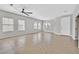 Spacious living room with large windows, tile floors, ceiling fan, and a bright, airy atmosphere at 6150 Bunker Commons Ct, Las Vegas, NV 89108