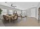 Staged open-concept living room, showcasing dining area, tile floors, and plenty of natural light at 6150 Bunker Commons Ct, Las Vegas, NV 89108