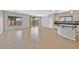 Combined living and kitchen area with a sliding glass door, tile floors, and sleek countertops at 6150 Bunker Commons Ct, Las Vegas, NV 89108