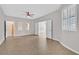 Large living room with neutral tile floors, bright natural light, and multiple doorways for easy navigation at 6150 Bunker Commons Ct, Las Vegas, NV 89108
