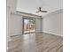 Main bedroom with hardwood floors, a ceiling fan, neutral paint and sliding door to backyard at 6150 Bunker Commons Ct, Las Vegas, NV 89108