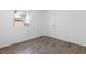 Bright bedroom featuring a window and laminate wood flooring at 6223 Foothill Blvd, Las Vegas, NV 89118