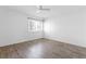 Bright, spacious bedroom with a ceiling fan, window, and laminate wood flooring at 6223 Foothill Blvd, Las Vegas, NV 89118