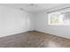 Bright bedroom featuring a window and laminate wood flooring at 6223 Foothill Blvd, Las Vegas, NV 89118