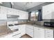 Bright kitchen featuring white cabinets, granite countertops, and modern appliances at 6223 Foothill Blvd, Las Vegas, NV 89118