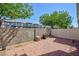 Fenced backyard featuring a brick-paved patio, small garden and a privacy wall at 6420 Extreme Shear Ave # 102, Henderson, NV 89011