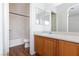 Bathroom with a tub, sink with wood cabinets and a large mirror at 6420 Extreme Shear Ave # 102, Henderson, NV 89011