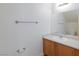 Bathroom with wood vanity, laminate countertop, framed mirror and white walls at 6420 Extreme Shear Ave # 102, Henderson, NV 89011