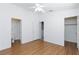 Bedroom with wood floors, ceiling fan, en suite bathroom, and walk in closet at 6420 Extreme Shear Ave # 102, Henderson, NV 89011