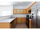 Kitchen featuring light wood cabinets, black gas range, stainless steel refrigerator and laminate countertop at 6420 Extreme Shear Ave # 102, Henderson, NV 89011