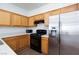 Bright kitchen featuring light wood cabinets, black gas range, stainless steel refrigerator and laminate countertop at 6420 Extreme Shear Ave # 102, Henderson, NV 89011