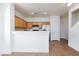Bright kitchen with light wood cabinets, stainless steel refrigerator and breakfast bar seating at 6420 Extreme Shear Ave # 102, Henderson, NV 89011