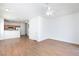 Open-concept living area with wood-look floors, white walls, and a view of the kitchen at 6420 Extreme Shear Ave # 102, Henderson, NV 89011