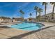 Community swimming pool surrounded by palm trees and well-kept landscaping at 6420 Extreme Shear Ave # 102, Henderson, NV 89011