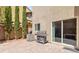 Paver patio and grill overlooking small yard with manicured trees at 6731 Sumatra St, Las Vegas, NV 89166