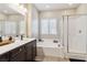 Bright bathroom features a soaking tub and separate glass shower at 6731 Sumatra St, Las Vegas, NV 89166