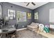 Charming bedroom with window view, gray walls, modern fan, and unique monster-themed decor at 6731 Sumatra St, Las Vegas, NV 89166