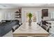 Open-concept dining and living area featuring tile floors, sliding glass doors, modern decor and lots of light at 6731 Sumatra St, Las Vegas, NV 89166