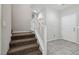 Welcoming entryway with neutral walls, tile floor, stairs with carpet, and a white front door at 6731 Sumatra St, Las Vegas, NV 89166