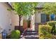 Inviting front entrance with stone accents, manicured landscaping, and charming gated walkway to private courtyard at 6731 Sumatra St, Las Vegas, NV 89166