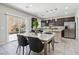 Bright kitchen with stainless steel appliances, a granite countertop island, and an adjacent dining area with backyard access at 6731 Sumatra St, Las Vegas, NV 89166