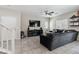 Inviting living room featuring a modern gray sectional, large TV, and elegant tile flooring at 6731 Sumatra St, Las Vegas, NV 89166