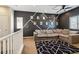 Loft space with accent wall, ceiling fan, and plush sectional sofa at 6731 Sumatra St, Las Vegas, NV 89166