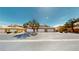 Charming townhomes featuring private garages and mature landscaping, set under a sunny sky at 6901 Cobre Azul Ave # 202, Las Vegas, NV 89108