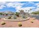 Exterior view of a desert-landscaped community featuring cacti, desert plants, and palm trees at 6901 Cobre Azul Ave # 202, Las Vegas, NV 89108