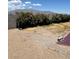 Spacious backyard featuring shrubbery along the cinder block fence and gravel at 7650 Butterscotch Ct, Las Vegas, NV 89131