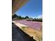 Backyard featuring a covered pool, graveled area, and a cinder block fence at 7650 Butterscotch Ct, Las Vegas, NV 89131