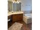 Bathroom featuring granite countertop vanity and soaking tub at 7650 Butterscotch Ct, Las Vegas, NV 89131