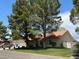 Charming single-story home featuring a well-manicured lawn and mature trees at 7650 Butterscotch Ct, Las Vegas, NV 89131
