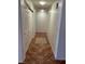 Narrow hallway with tile floors and access to multiple rooms at 7650 Butterscotch Ct, Las Vegas, NV 89131