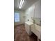 Functional laundry room with white cabinets, sink and window at 7650 Butterscotch Ct, Las Vegas, NV 89131