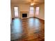 Bright living room with wood floors, fireplace, and natural light from multiple windows at 7650 Butterscotch Ct, Las Vegas, NV 89131
