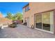 Spacious backyard patio with stone pavers, outdoor kitchen area, and sliding glass doors at 7651 E Anatolian St, Las Vegas, NV 89166