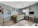 Bedroom with hard wood floors, double-hung window and light blue walls at 7651 E Anatolian St, Las Vegas, NV 89166