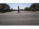 A paved entry road with a decorative median leads to a gated residential complex at 833 Aspen Peak Loop # 1524, Henderson, NV 89011