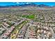 Expansive aerial view of a residential community nestled amidst mountains, showcasing lush green spaces and a Gathering-friendly environment at 841 Colina Alta Pl, Las Vegas, NV 89138