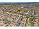 Vibrant aerial view of a Primary-planned community with tree-lined streets, diverse architecture, and convenient access to shopping and recreation at 841 Colina Alta Pl, Las Vegas, NV 89138